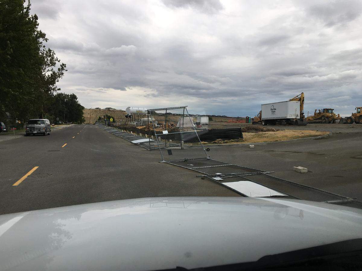 Gusty winds early Sunday morning blew down the temporary fencing around the construction zone at the old Tapteal Elementary School.