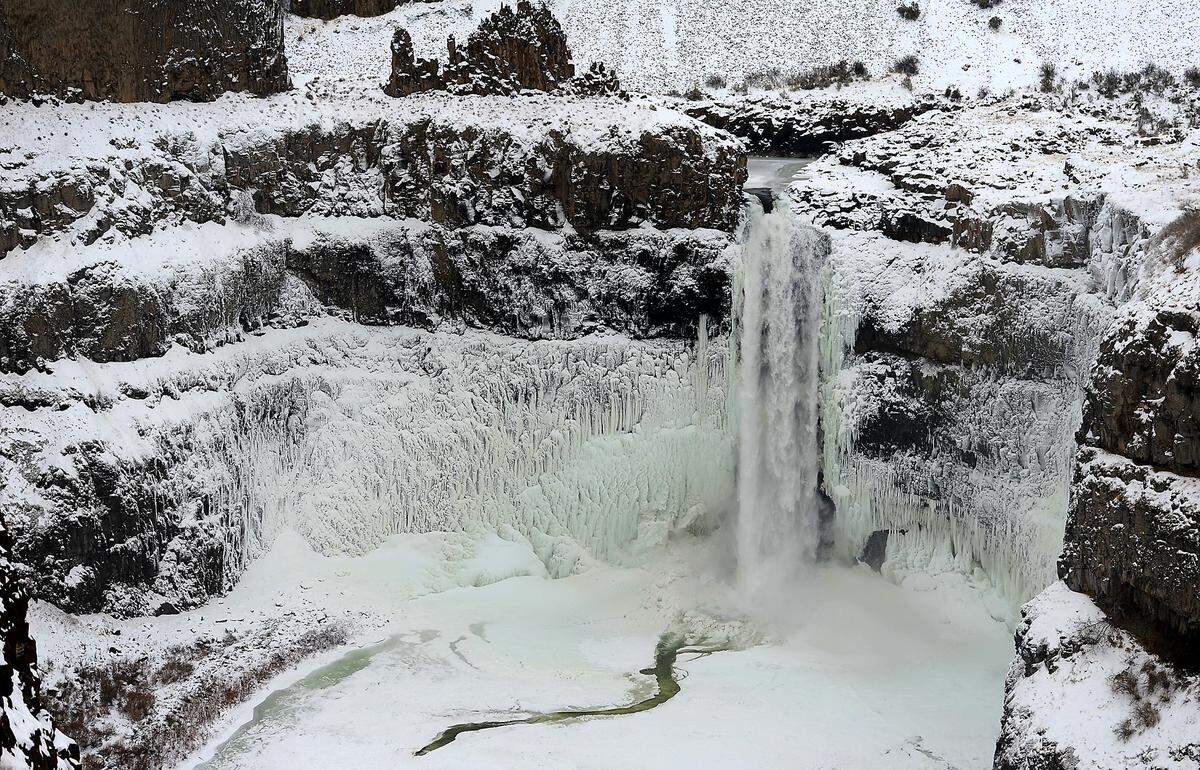 Snow and ice covers the Palouse Falls during chilly December winter weather in Franklin County. 