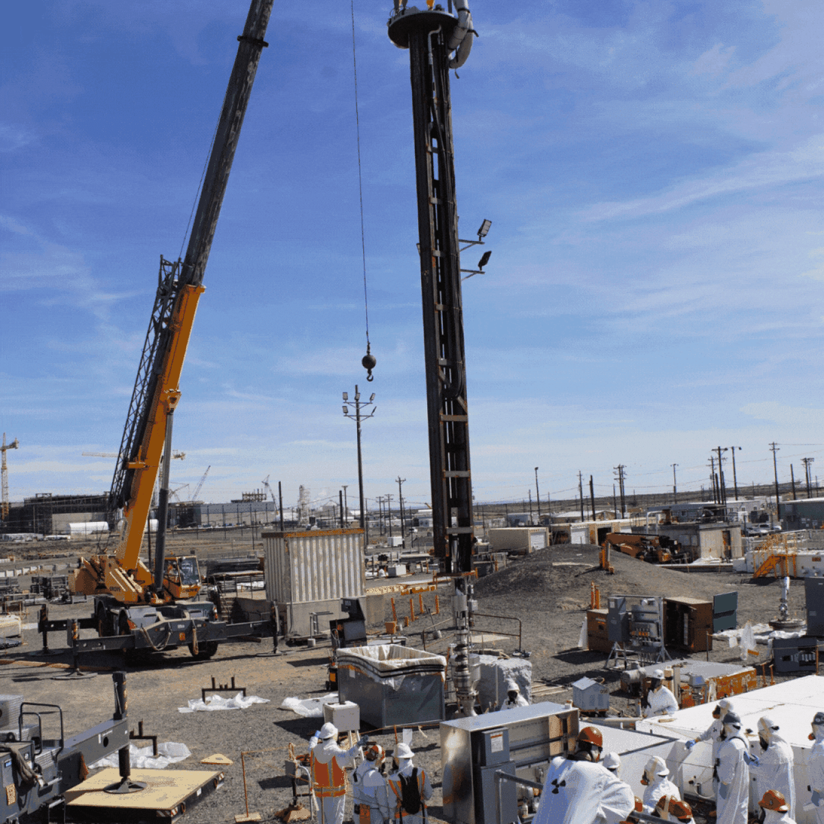 Workers with Hanford Tank Waste Operations & Closure guide a new pump into Tank A-106 to retrieve radioactive waste from the aging tank. Emptying solid waste from the tank started in late January.