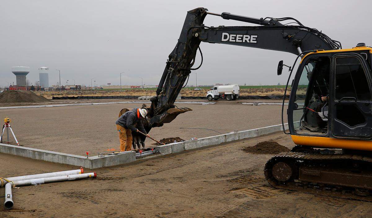 Construction crews use an excavator and a shovel to work on the new Mid-Columbia Gymnastics Academy building at 5102 Convention Drive, just north of Fairchild Cinema in west Pasco. The $3 million project, which includes a 17,500-square-foot pre-engineered building. is being constructed for owner Len Softich by Hummel Construction & Development LLC.