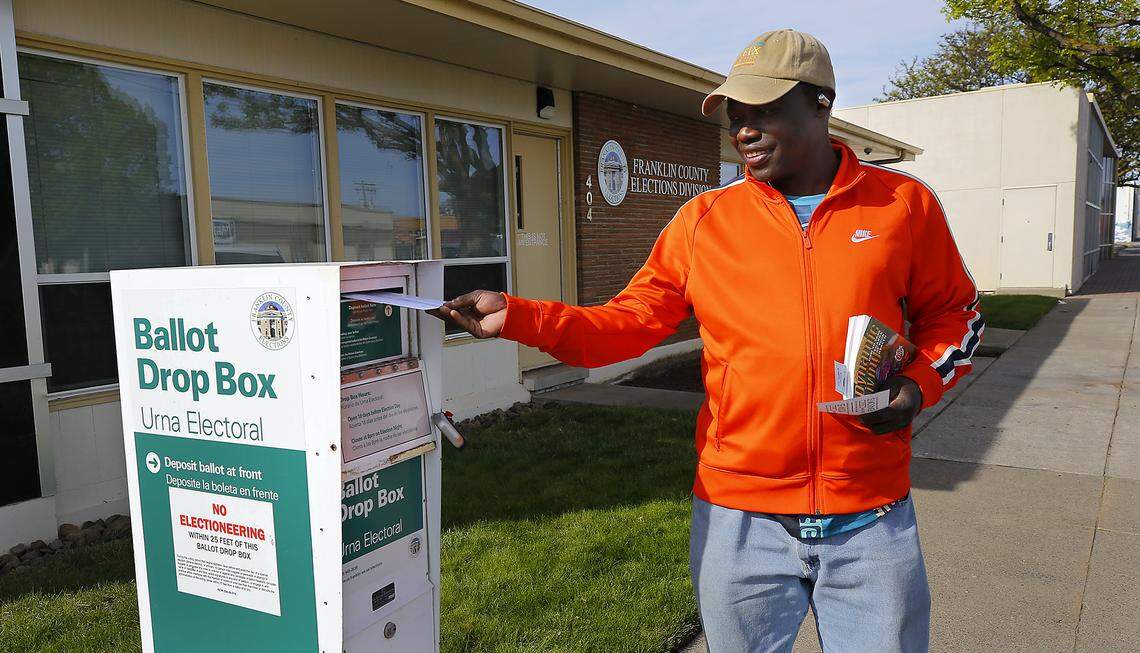Moses Elizai places his ballot into the drop box early Tuesday outside the Franklin County Elections Division office building at 404 W. Clark St. in Pasco. 