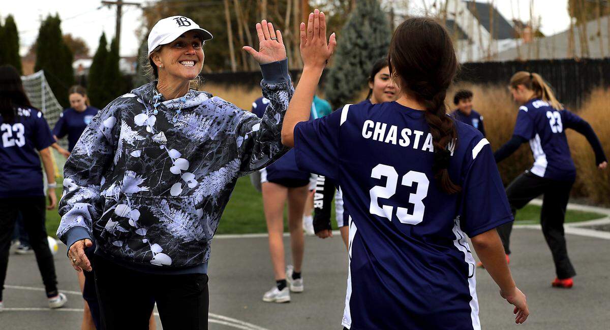Brandi Chastain, two-time Olympic gold medalist and FIFA Women’s World Cup champion, gives a high-five to one of several dozen youth that participated in a soccer skill clinic during her visit at the Boys & Girls Club of Benton and Franklin Counties site in Kennewick.