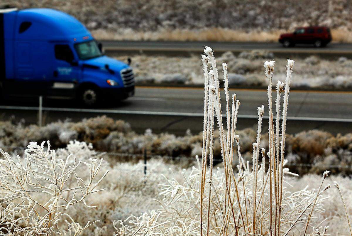 A frosty landscape frames traffic traveling on Interstate 82 south of Kennewick at the start of the Thanksgiving holiday week. Travelers heading out from the Tri-Cities may hit freezing rain and snow.