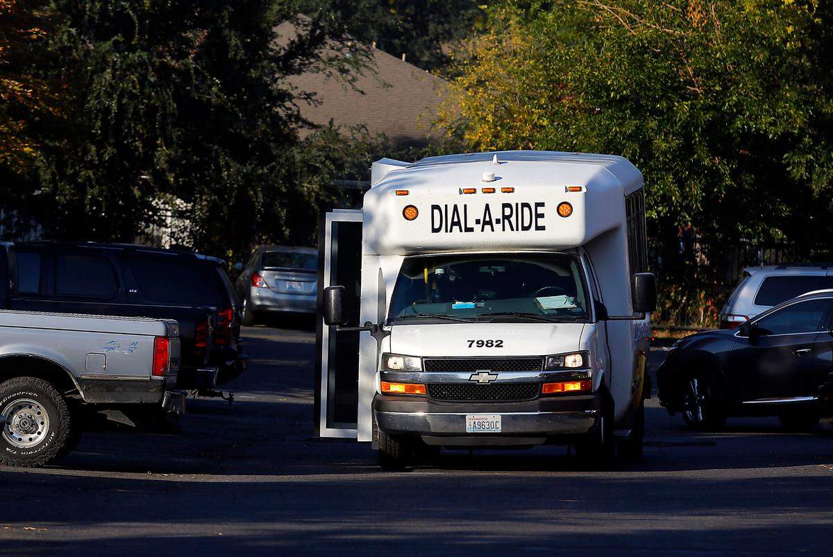 A Ben Franklin Transit Dial-A-Ride bus stops an apartment complex off West Fourth Avenue near downtown Kennewick.