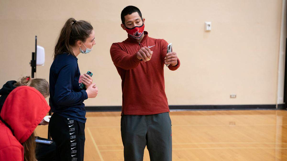 Kennewick High graduate Jarod Gonzales works with Emma Clark, a member of the Northwest Nazarene University women’s basketball team, during a workout earlier this month.