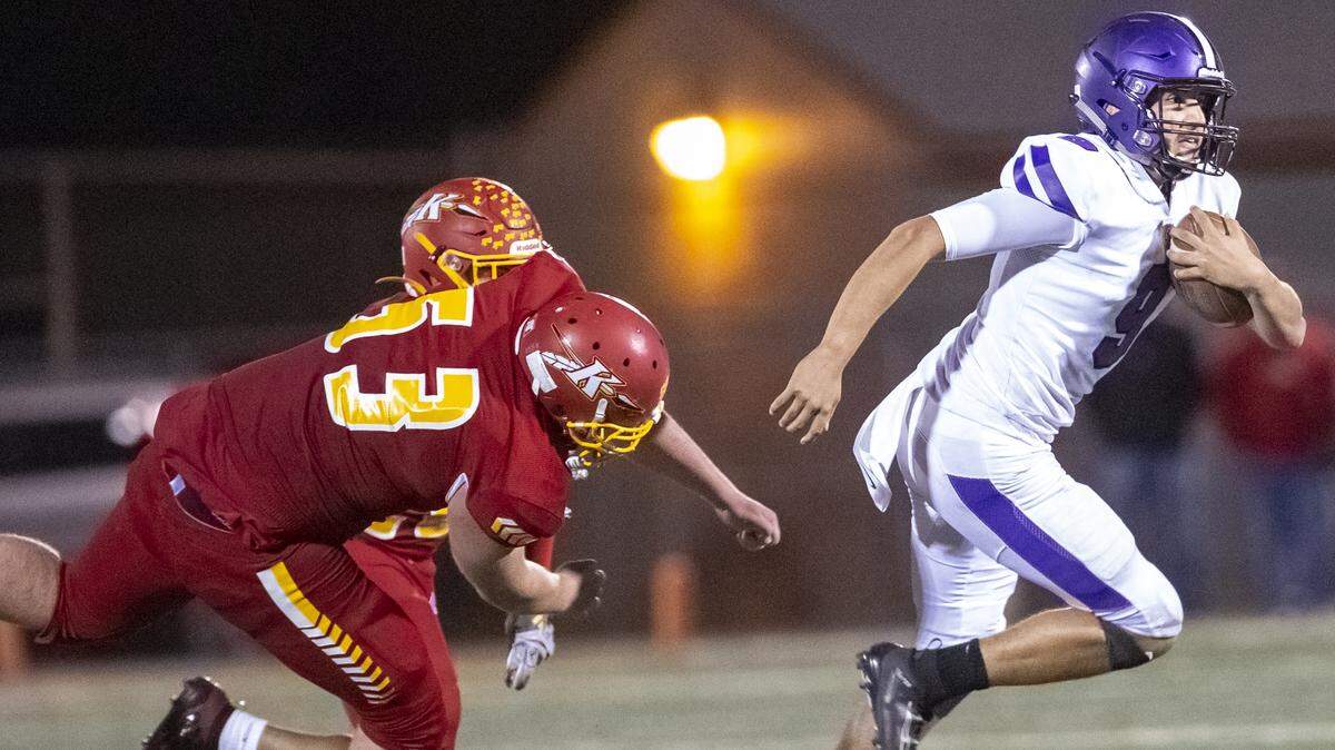 Kamiakin’s Dylan Withers (53) attempts to sack Pasco’s quarterback Armani Reyes (9) as he runs with the ball during a Mid-Columbia Conference football game at Lampson Stadium in Kennewick on Friday. Kennewick defeated Pasco 43-25.