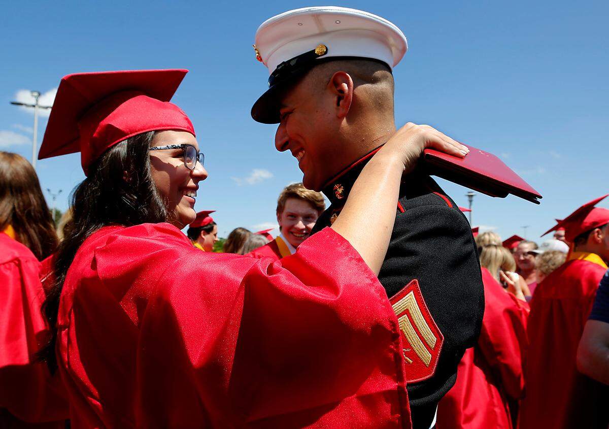 Kamiakin graduate Zoe Arambul hugs her older brother, Donovan, after he surprised her following Saturday’s Kennewick’s school commencement ceremony at the Toyota Center in Kennewick. The two haven’t seen each other in nearly four years because of his assignments in the U.S. Marines.