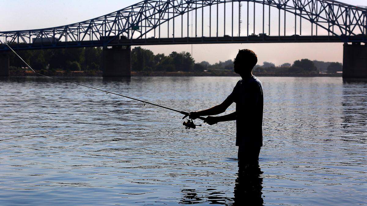 Ryker Durham, 18, of Kennewick, cools off during early summer morning bass fishing trip in Columbia Park on the Columbia River near the blue bridge. The Tri-Cities is under an excessive heat warning.