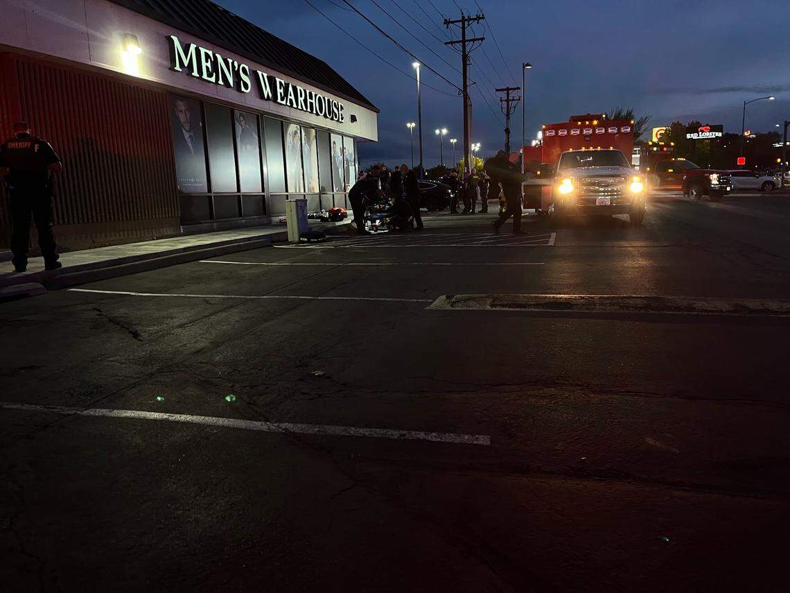 A teen with a gunshot wound to the leg is loaded Friday night into an ambulance near Men’s Warehouse on Columbia Center Boulevard in Kennewick.