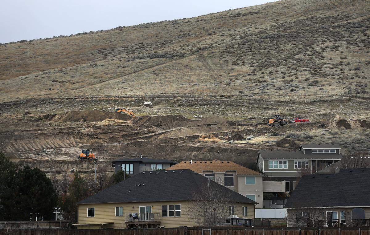 Heavy equipment works on scraping out a road on the south end of Candy Mountain above existing homes on Hershey Lane and Ferrero Drive in West Richland.