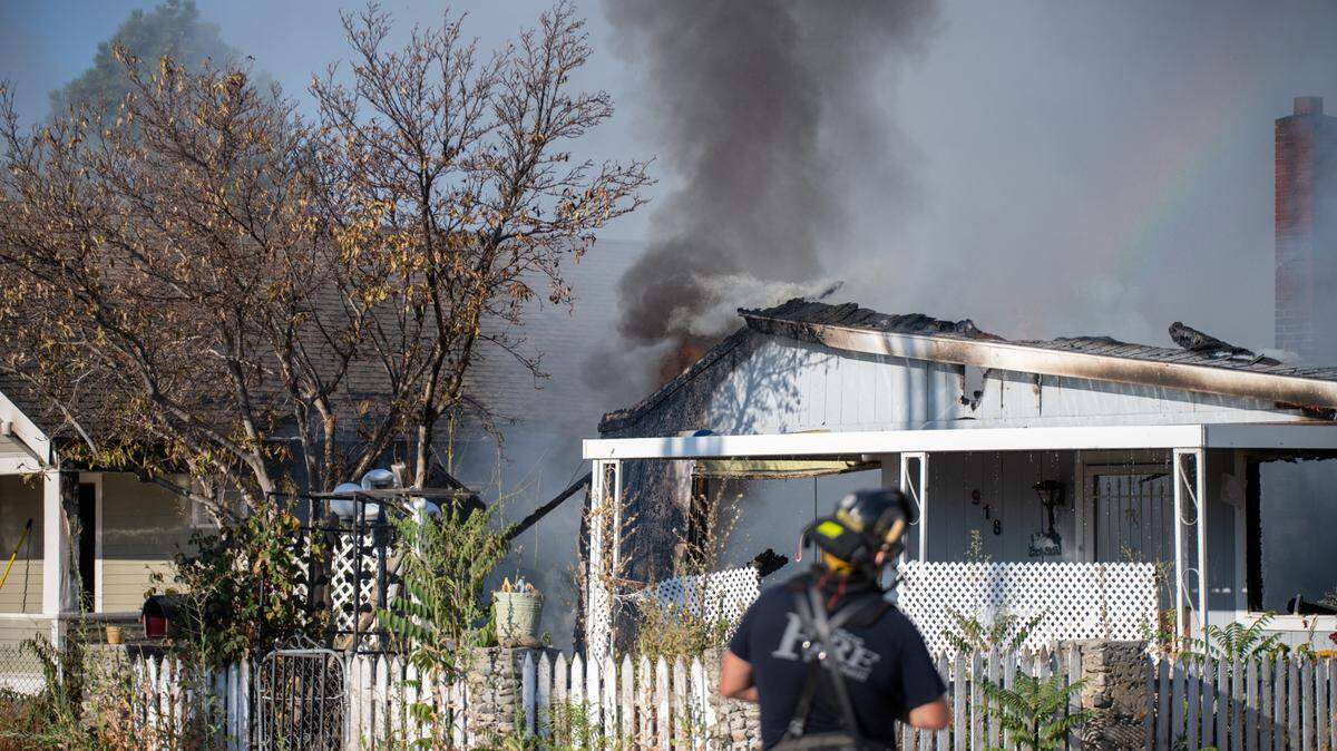 Pasco firefighters work to control a fire that spread from an abandoned house to this occupied home at 920 S. 5th Ave. shortly before 7 a.m. Saturday. Everyone got out safely, said Ben Shearer with the Pasco Fire Department.
