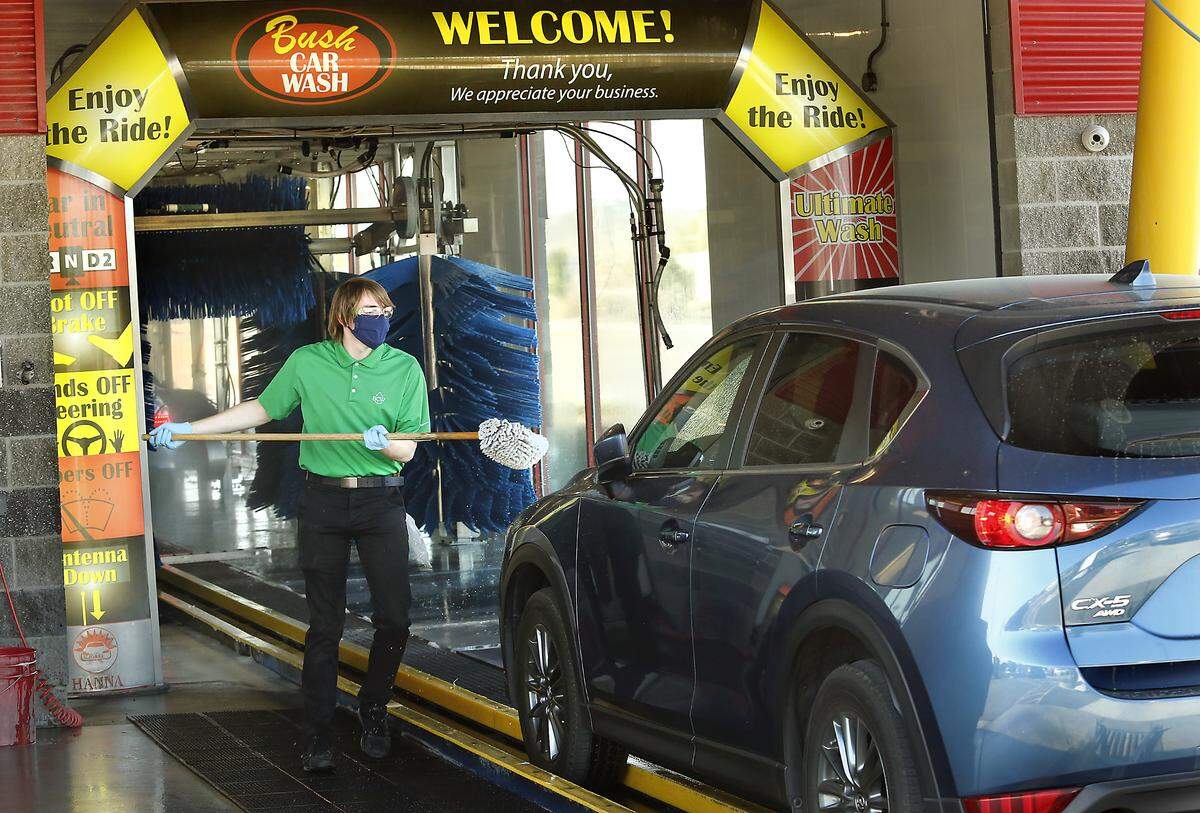 Josh Johnson, Bush Car Wash employee, scrubs the windshield of a customer’s car Tuesday morning at the chain’s Edison Street location in Kennewick. The business opened its seven locations across the Tri-Cities and Walla Walla  despite the governor’s stay-at-home order from. “We have listened to the advice of local authorities and will also be following guidelines of our governor,” the car wash posted on Facebook.