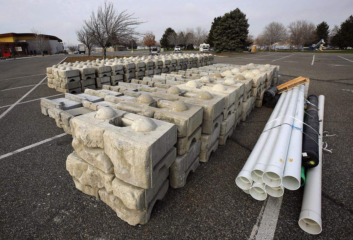 Construction materials for a City of Richland project to repair the Columbia Point Marina Park shoreline retaining wall are staged in the parking lot of the park along the Columbia River. Starting January 5, the project will require a temporary detour of the Riverfront Pathway Trail near Columbia Point Marina.