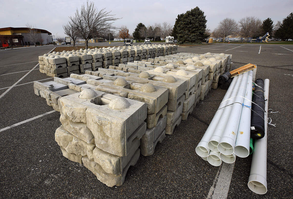 Construction materials for a City of Richland project to repair the Columbia Point Marina Park shoreline retaining wall are staged in the parking lot of the park along the Columbia River. Starting January 5, the project will require a temporary detour of the Riverfront Pathway Trail near Columbia Point Marina.