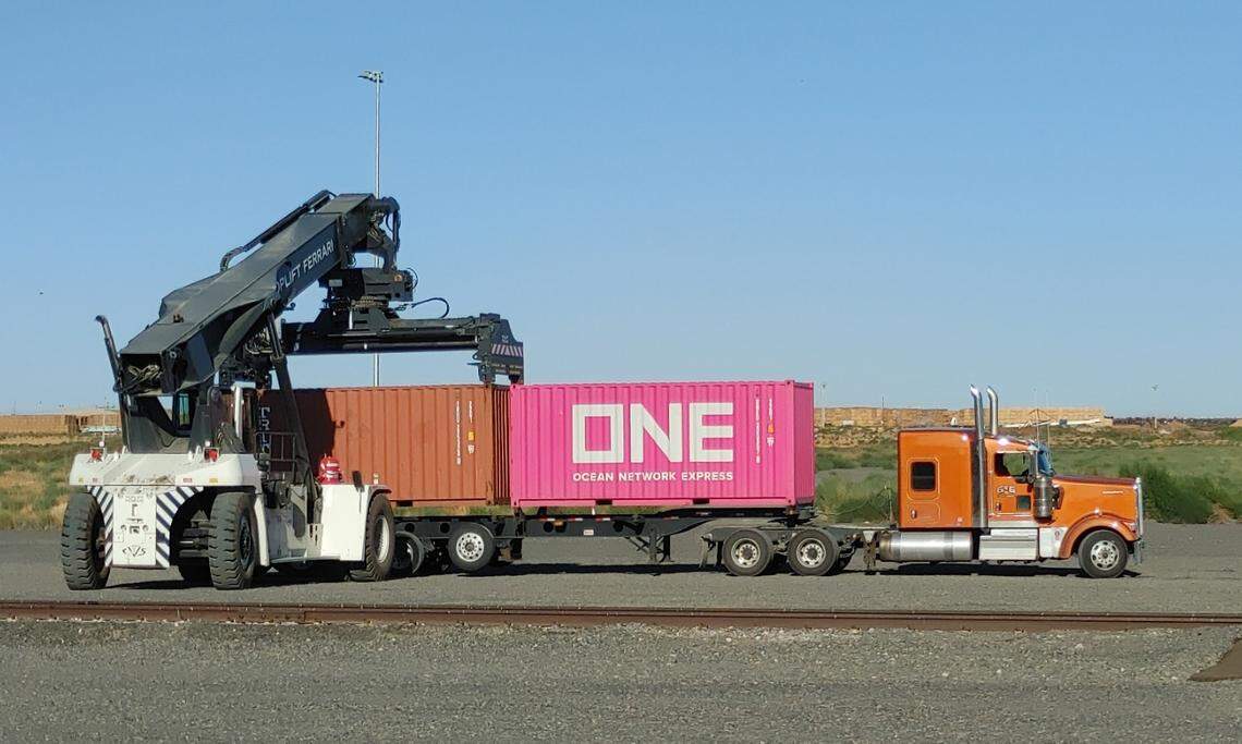 A shipping container is placed on a truck at Tri-Cities Intermodal at Wallula Gap in western Walla Walla County. The company revived shipping and logistics services at the former Tiger Cool Express complex in early 2024. Tiger shut down in mid-2023.