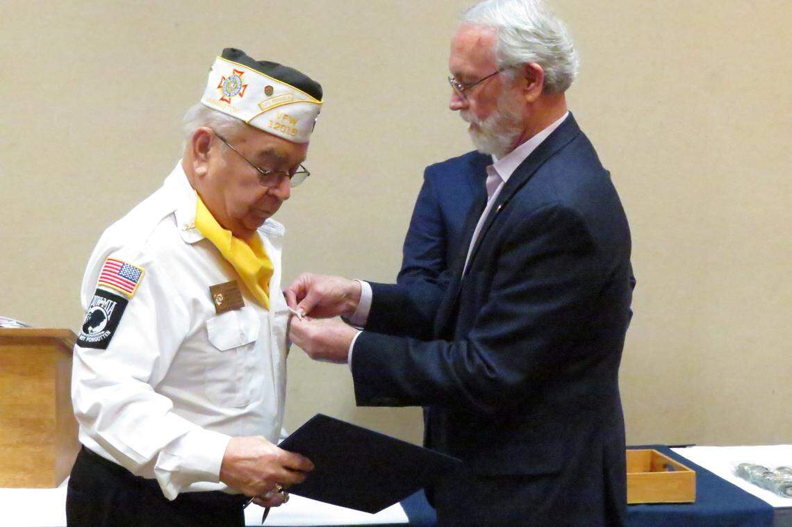 Rep. Dan Newhouse, R-Sunnyside, puts a pin on Navy veteran Jerry Peltier’s shirt during a pinning ceremony at the Richland Red Lion.