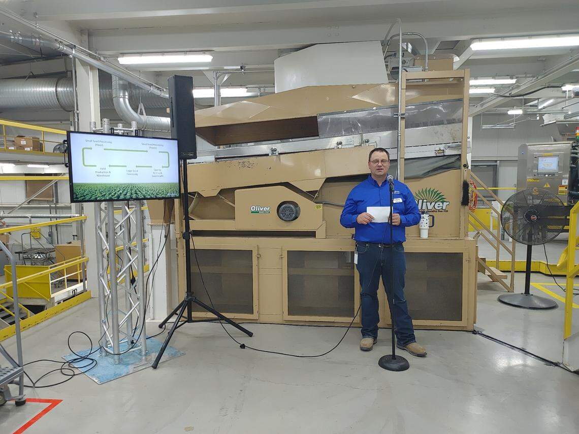 Casey Young of Syngenta Group explains how large vegetable seeds, including sweet corn, are processed for growers during a tour of the company’s newly-expanded Pasco vegetable seed plant. Young is regional processing manager for North America and Pasco site manager for the state-of-the-art facility, which processes large and small seeds from hundreds of fruits and vegetables for a global audience.