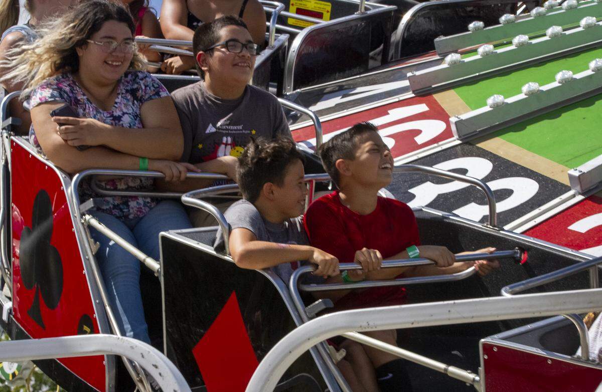 Kids ride Thursday on the Casino, a new thrill ride at the Benton Franklin Fair & Rodeo in Kennewick.