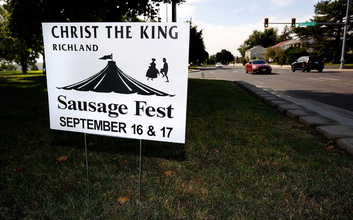 A sign for the 2022 Sausage Fest event being held by Christ The King in Richland is displayed in front of a house on Stevens Drive just a couple blocks from the private Catholic school.