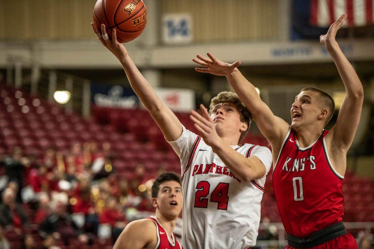 Trevor Rogers of Finley’s River View HS goes in for a lay-up against Shane Mcgaughey-Fick of King’s Knights