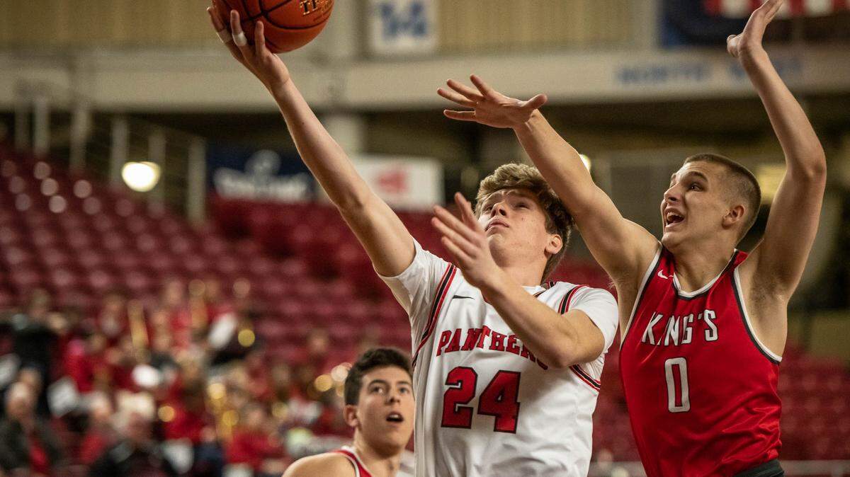 Trevor Rogers of Finley’s River View HS goes in for a lay-up against Shane Mcgaughey-Fick of King’s Knights
