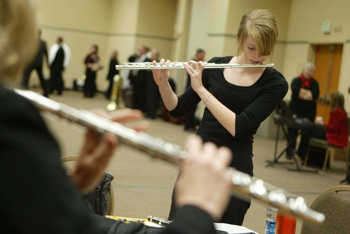 An unnamed flautist rehearses before the Mid-Columbia Symphony’s 2010 holiday concert in 2010.