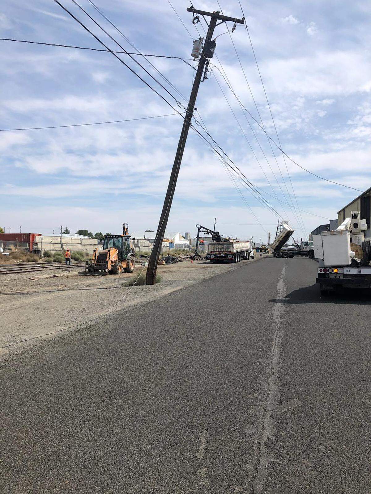 A dump truck knocked over five utility poles after getting snagged on power lines in downtown Kennewick Wednesday.
