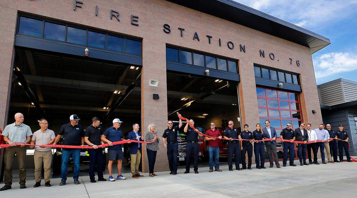 Firefighters, dignitaries and community members take part in a ribbon cutting ceremony of the new Richland Fire Department Station 76 in south Richland. Instead of the traditional ribbon and scissors, a pair of fire hoses were uncoupled to mark the special occasion.