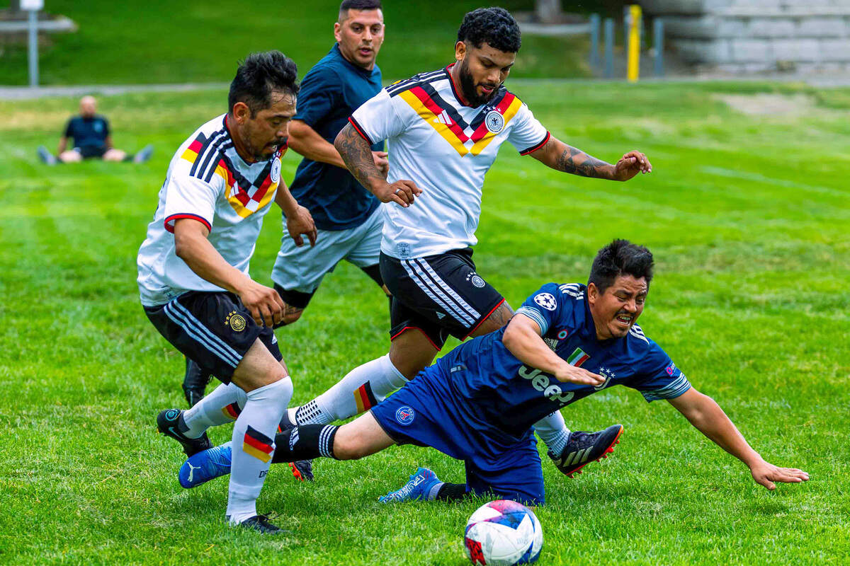 Leodan Hernandez, foreground, of the black team falls while pursuing the ball as Alex Castro and Euelis Mendoza of Tercer Tiempo FC and Julio Meralez of the black team converge on the play.