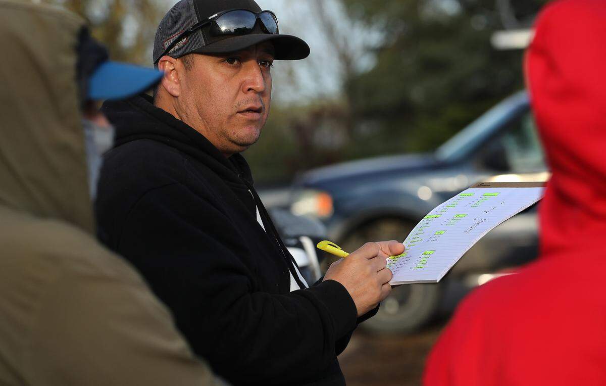 Farm manager Arturo Mendoza organizes the work roster for the farm workers harvesting asparagus at Schreiber Farms.