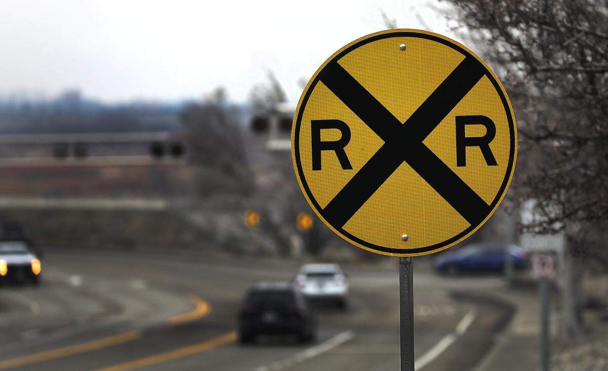 Railroad crossing sign for motorists traveling northbound on North Steptoe Street.