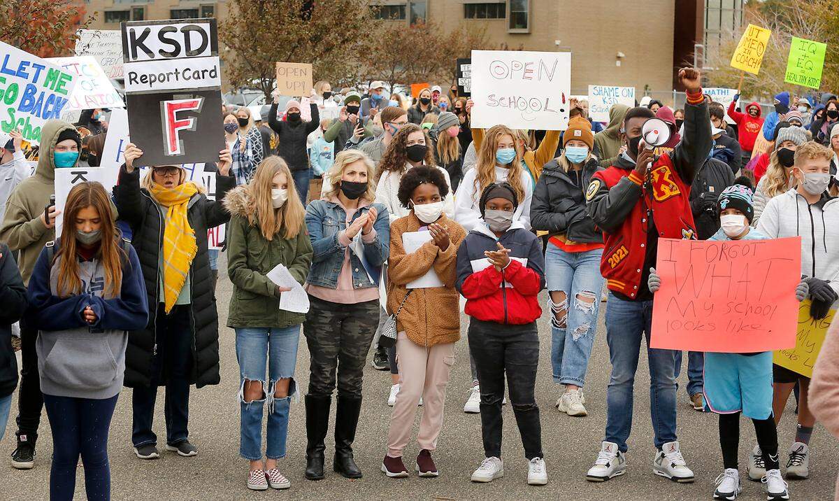 Several hundred students, parents and teachers gather in the Kennewick School District administration building parking lot for a rally to open schools for in-person learning following the school board’s recent decision to delay re-opening middle and high schools until February.