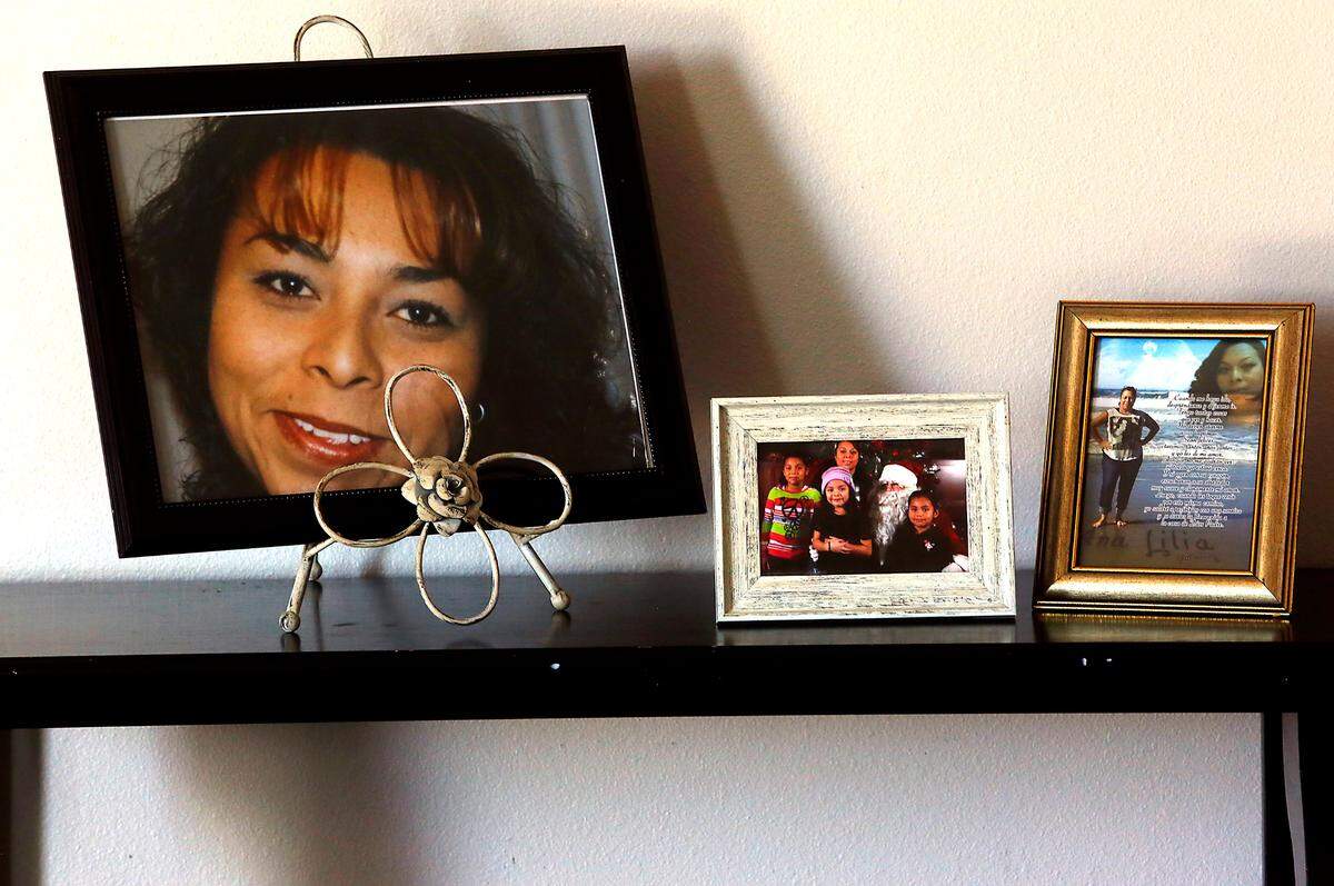 Family photos and a portrait of Ana Gutierrez-Ramirez are prominently displayed in the family room of their Pasco home.
