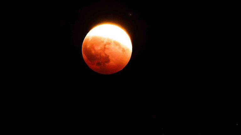 Reddish-orange moon charms Tri-Cities during partial eclipse
