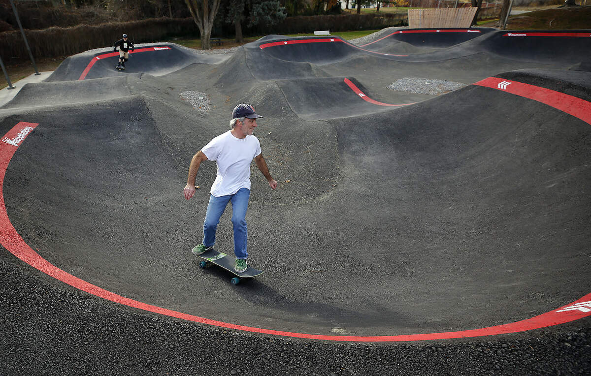 Skateboarders John Sutton, in the lead, and Frank Ward, both of Kennewick zoom around the new Vancouver Park pump track following Thursday's grand opening for bicyclists and skateboarders.