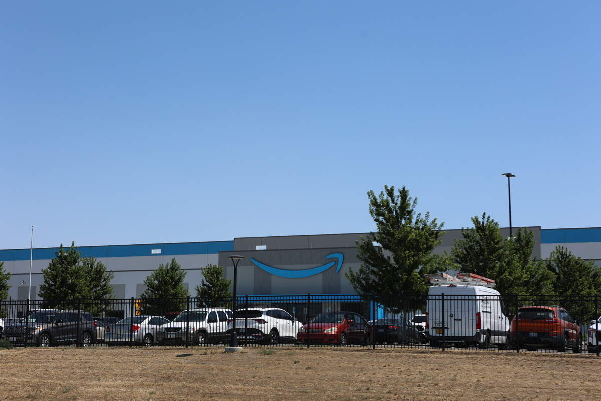 Employee vehicles fill the parking lot at the Amazon Inc. warehouse near Sacajawea State Park in Pasco. The distribution facility will employ 1,000-1,500.