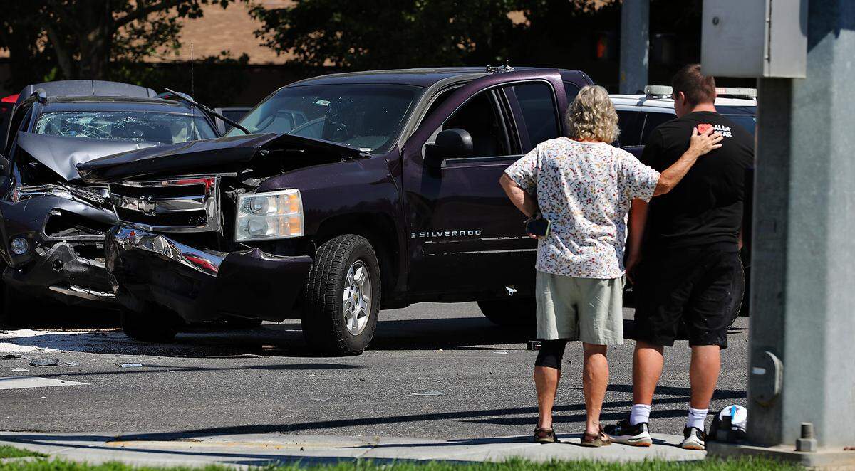 A passerby provide a reassuring hand on the shoulder of a young occupant involved Wednesday in a two-vehicle crash at the intersection West 10th Avenue and South Union Street in Kennewick. Police reported at least a couple people where taken to the hospital with non-life threatening injuries.