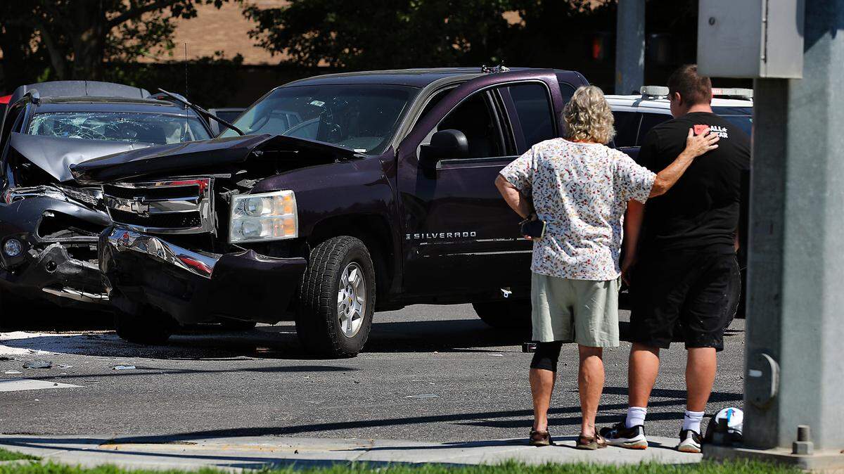 A passerby provide a reassuring hand on the shoulder of a young occupant involved Wednesday in a two-vehicle crash at the intersection West 10th Avenue and South Union Street in Kennewick. Police reported at least a couple people where taken to the hospital with non-life threatening injuries.