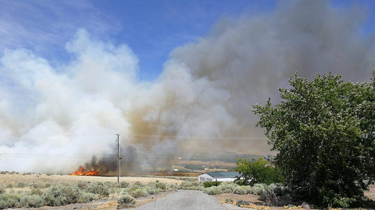 Amanda Vann of Benton City shot this photo of the wildfire near Yakitat Road on Thursday. Vann said the fire is headed east and has passed two houses.