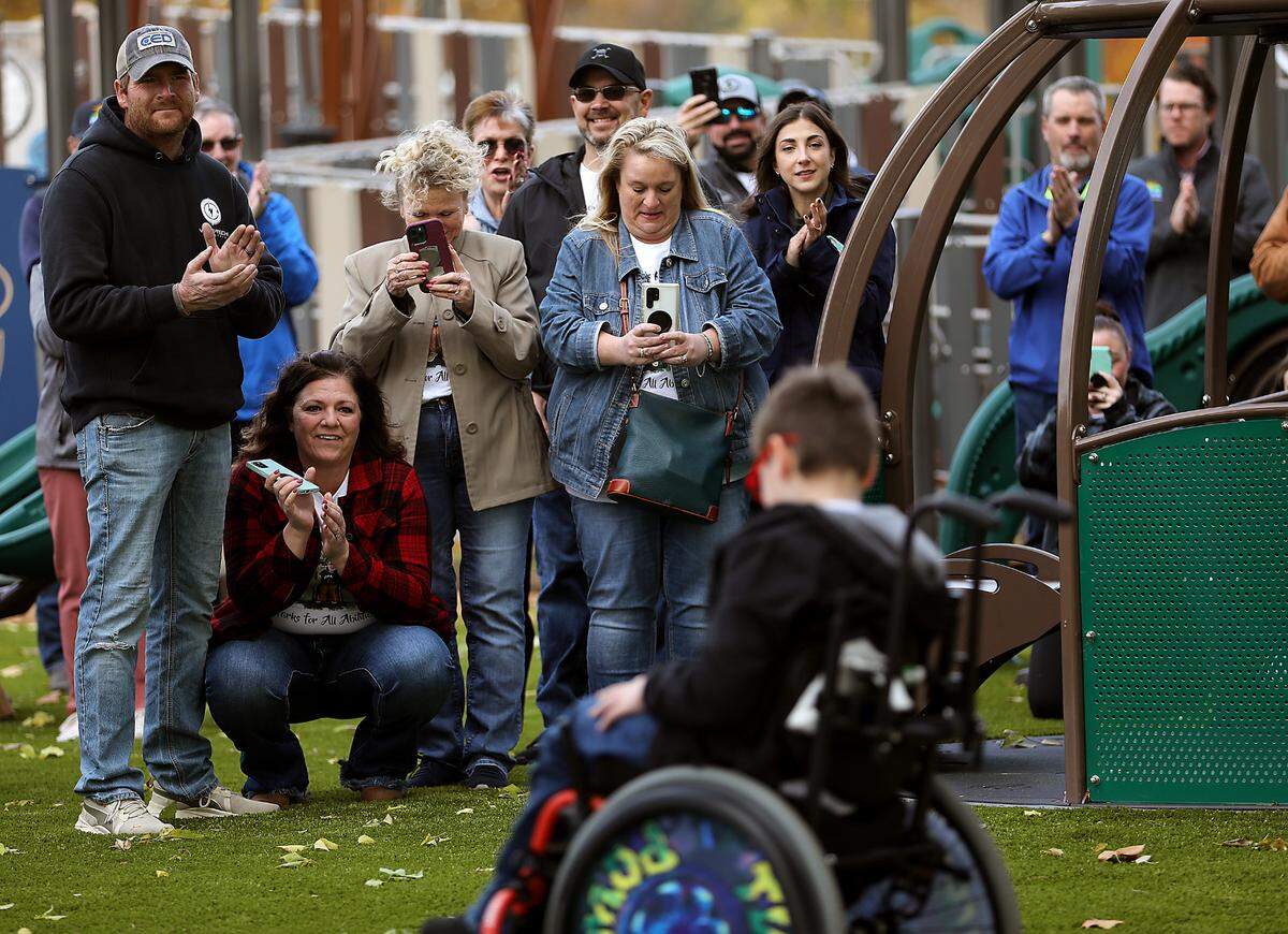 Family and friends celebrate the grand opening of the new Kason’s Korner inclusive playground area at the Playground of Dreams in Kennewick.