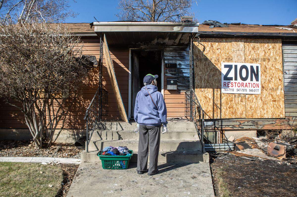 Charlene Wolf, 77, stands outside of her home at 1411 Stevens Drive in Richland the day after it was gutted by a house fire which started under the back porch and spread to the home.