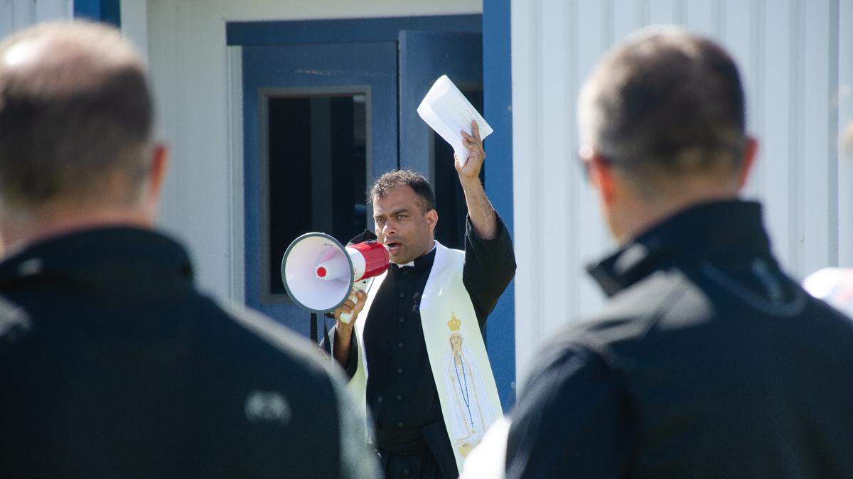 Father Lourdu Mummadi, of St. Patrick Catholic Parish in Pasco, Washington, leads a prayer on Monday, June 3, at the groundbreaking ceremony for the Tri-Cities Prep High School expansion project.