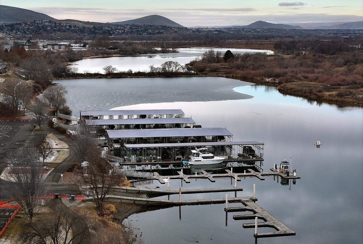 A plan to breach the causeway to the island will allow the Yakima River to flow around the island but led to closure of the longtime marina.