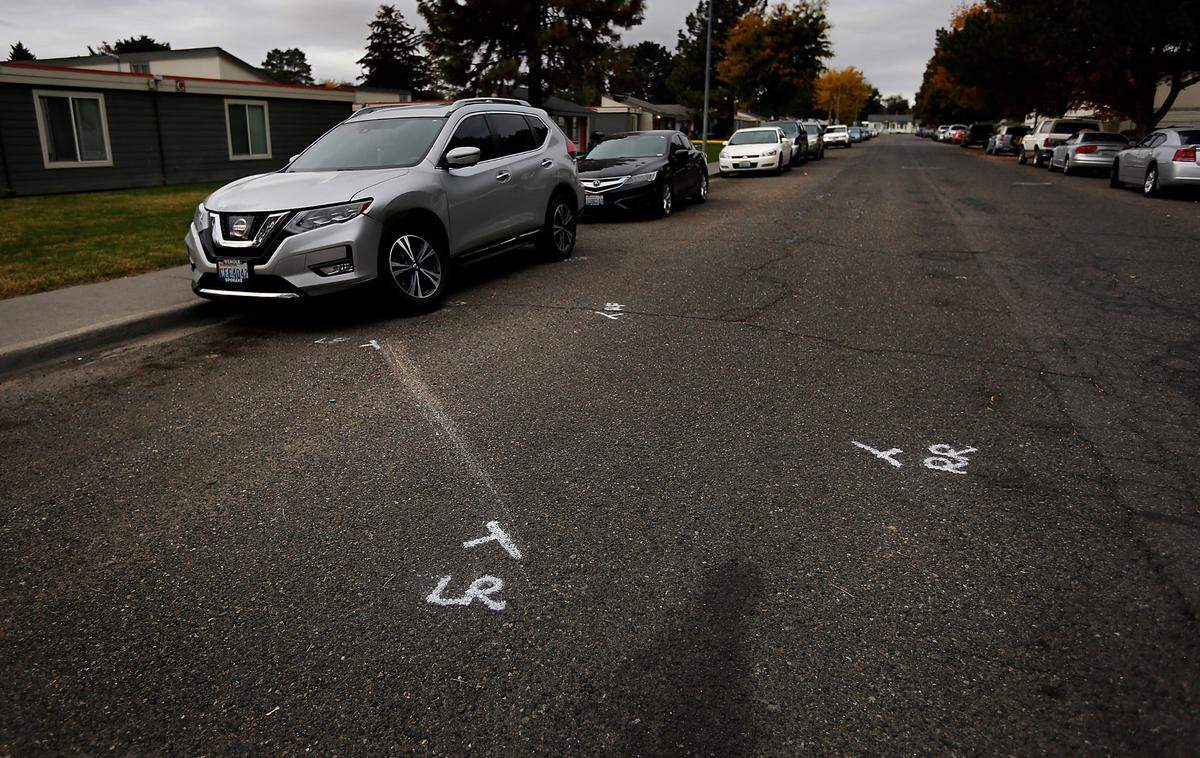 Police paint marks in the 1300 block of West Fifth Avenue in Kennewick show where the vehicle driven by Julian Chavez, 19, crashed Saturday night before he was found dead.