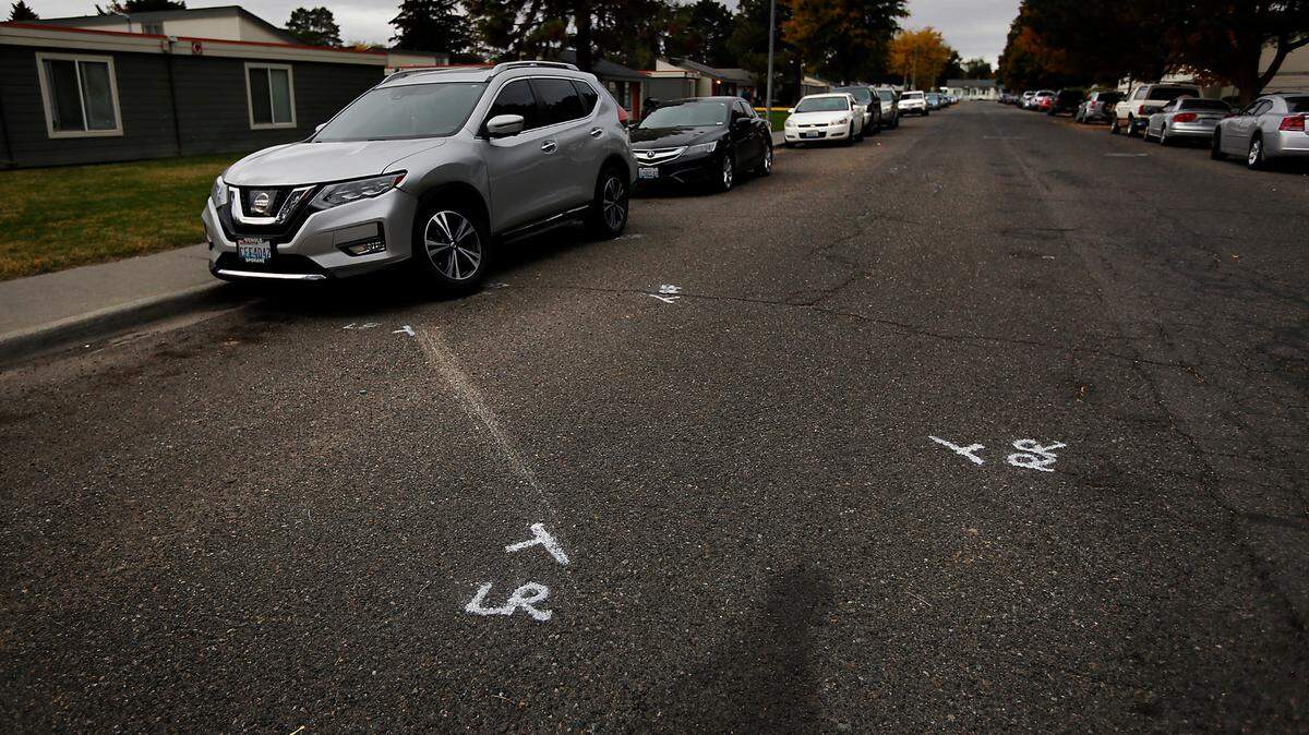 Police paint marks in the 1300 block of West Fifth Avenue in Kennewick show where the vehicle driven by Julian Chavez, 19, crashed Saturday night before he was found dead.