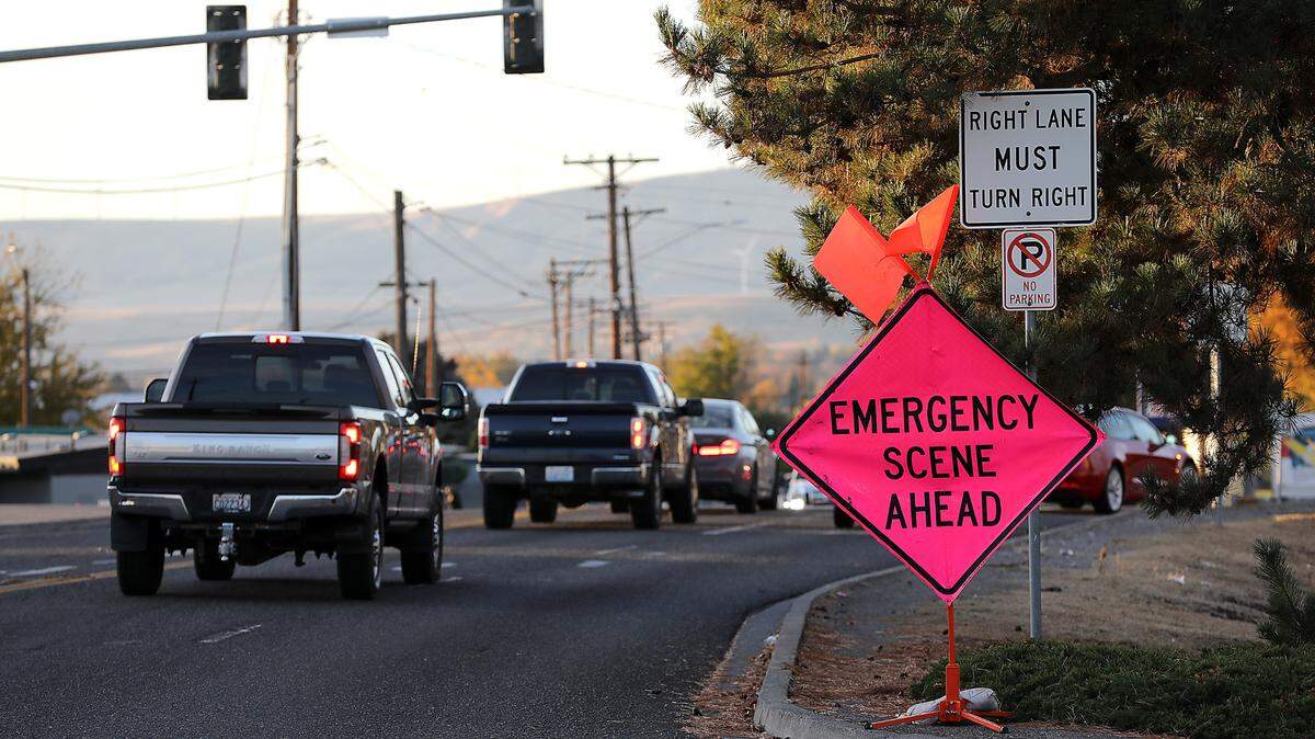 Emergency warning signs remain Tuesday morning near the intersection of South 28th Avenue and West Lewis Street in Pasco after a 65-year-old man was killed crossing the street.