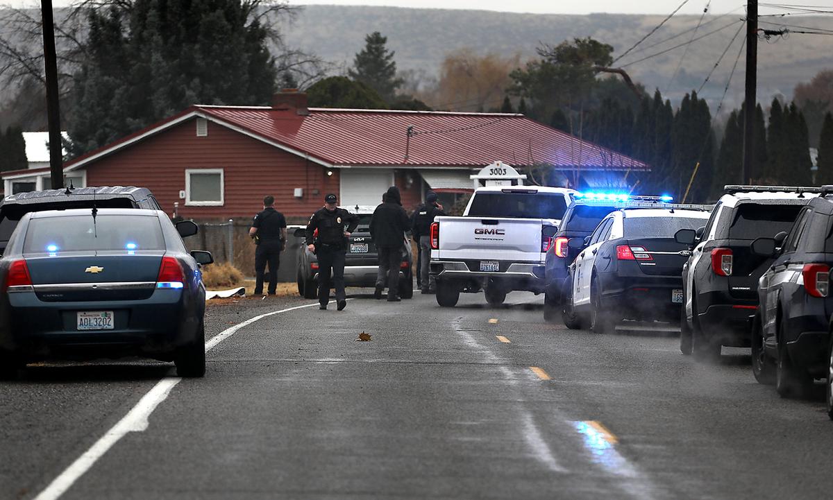 Kennewick police officers and Benton County Sheriff’s deputies investigate Monday morning’s fatal shooting scene in the 3000 block of South Jean Street.