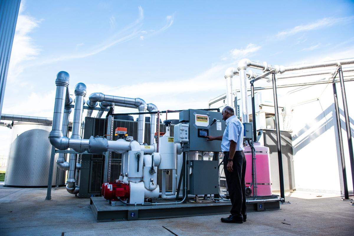 PNNL’s Srinivas Katipamula examines an energy storage system installed at PNNL as part of the Clean Energy and Transactive Campus project funded by Washington’s Clean Energy Fund. The device makes ice at night when the demand for electricity is low, then uses it to offset the electricity needed to cool the building when the demand and price for electricity is at its peak.