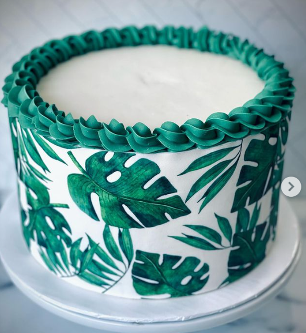 Tropical leaves themed chocolate cake for a luau graduation party by Simply Sweetz LLC, with (not pictured) pineapple cupcakes to match.