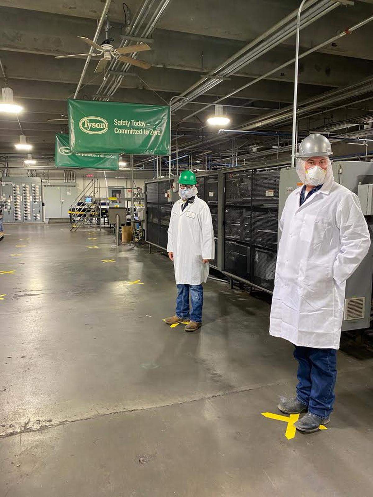 Yellow Xs mark spots six feet apart to help workers at Tyson Fresh Meats in Wallula maintain social distancing to help prevent the spread of the new coronavirus.